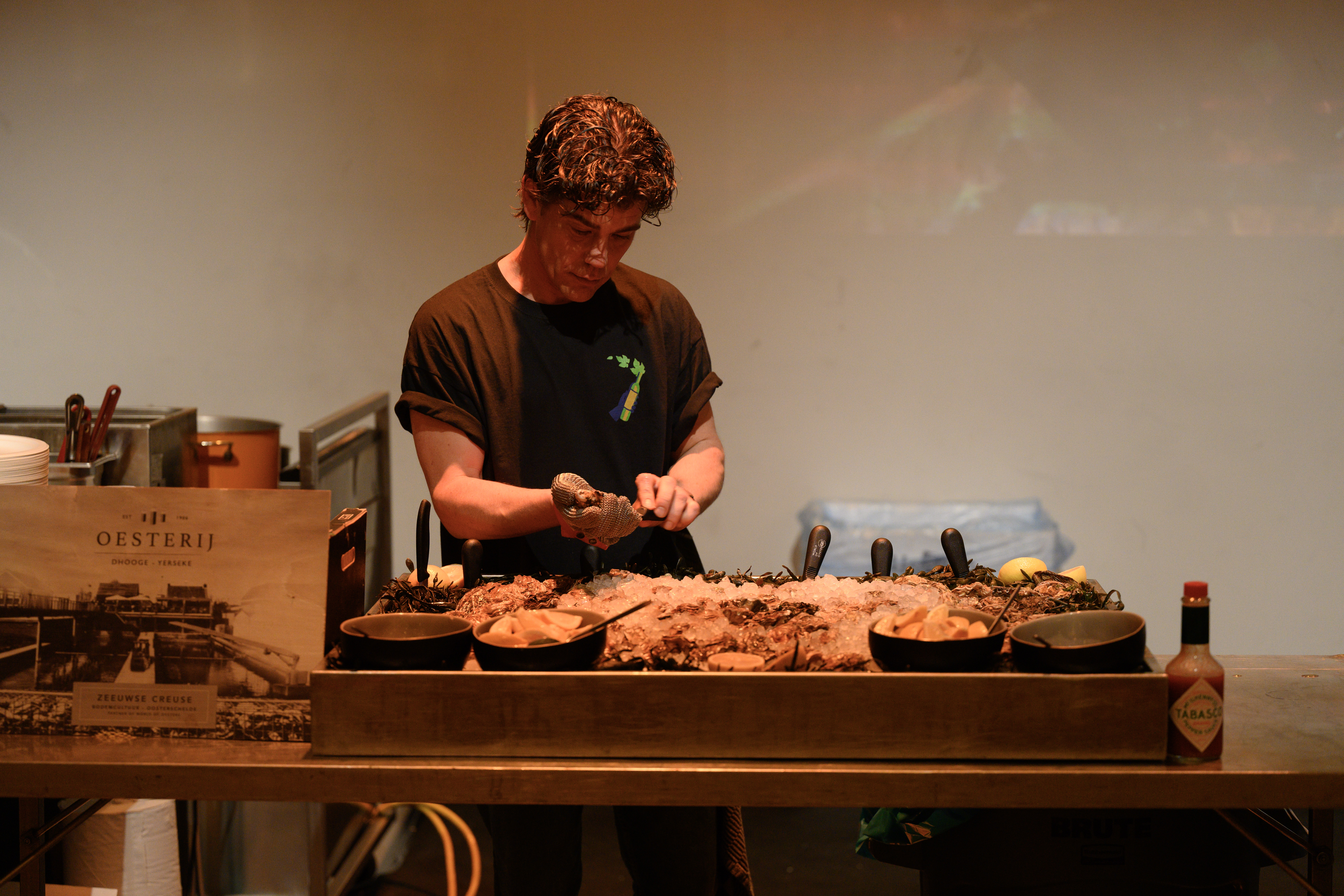 the kitchen plating family-style at the long table