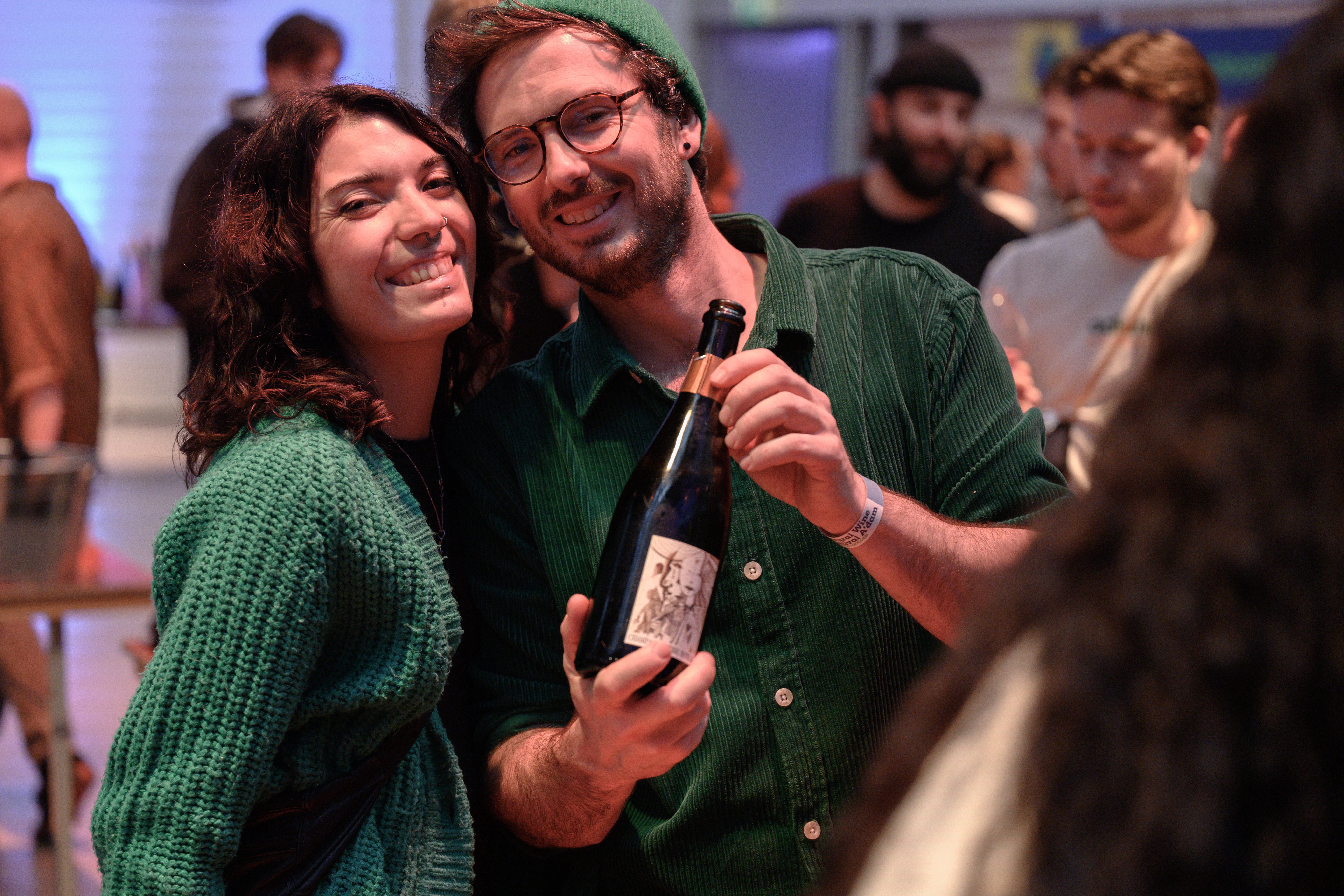 two visitors sharing a bottle at the festival